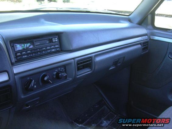 Dashboard of a 1992 Ford F-250, showing the radio, climate controls, and glove compartment