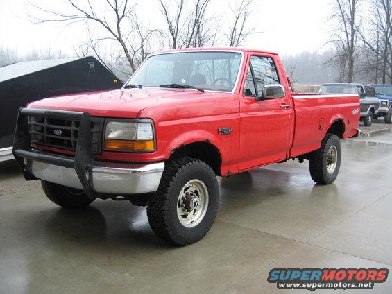 Red 1993 Ford F-250 pickup truck with brush guard and chrome bumper
