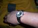 2004 Aston Martin Virage - A watch with a diamond-encrusted bezel is shown on a wrist, beside its branded box.