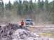 1989 Ford Bronco - A white SUV navigates a dusty off-road course, kicking up a cloud of dirt.