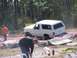 1989 Ford Bronco - A white 1989 Ford Bronco is stuck in the dirt during an off-road event.