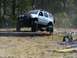 1989 Ford Bronco - An off-road SUV navigates a challenging course marked with orange ropes.