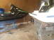 1995 Ford Mustang - Two watercraft, a jet ski and a boat hull, are stored in a garage.