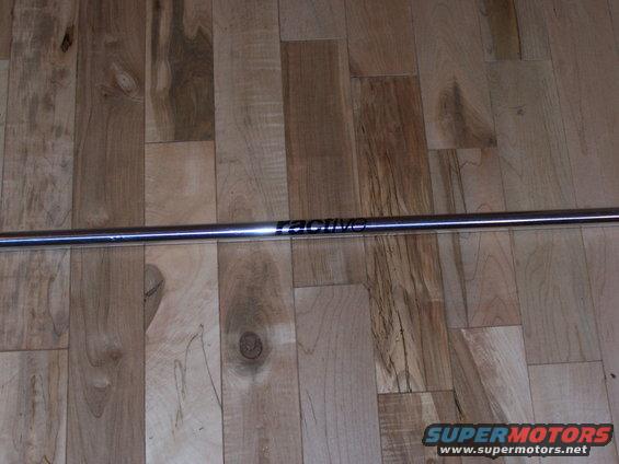 Chrome strut bar with 'RACING' logo on wooden floor