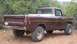 1990 Ford Bronco - This brown pickup truck features prominent International badging on the tailgate and is equipped with off-road tires.