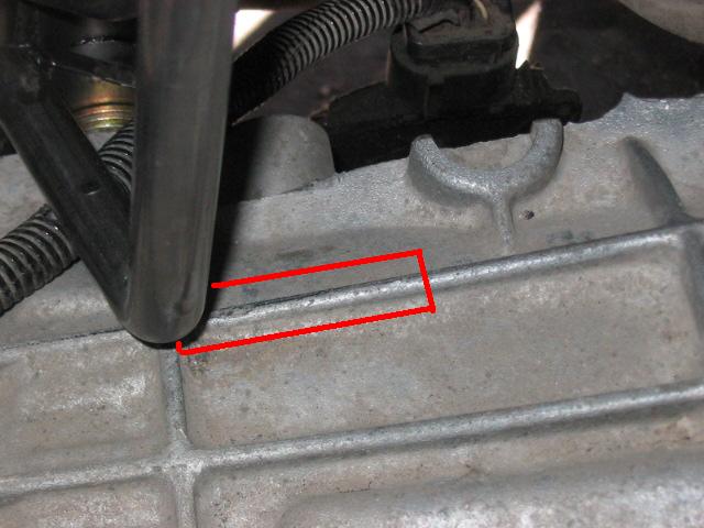 Close-up of a metal engine component with red markings