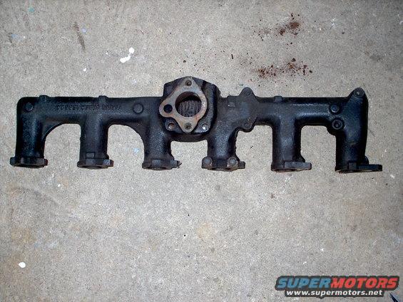 Exhaust manifold with visible casting numbers on concrete