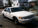 1999 Ford Crown Victoria - This 1999 Ford Crown Victoria is shown from a 3/4 front angle, highlighting its grille and overall body style.