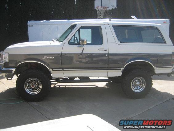 Side view of a lifted 1989 Ford Bronco with two-tone paint