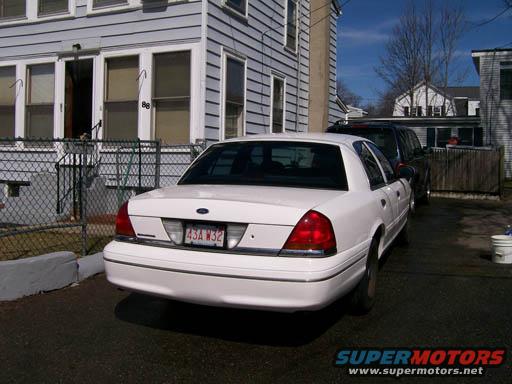 White Ford Crown Victoria, rear view, parked in driveway