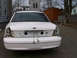 1999 Ford Crown Victoria - Rear view of a white Ford Crown Victoria undergoing repairs or modifications, with its bumper and taillights removed.