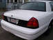 1999 Ford Crown Victoria - The rear of a white Ford Crown Victoria is shown, with a license plate reading 43A W32.
