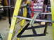 1979 Ford Bronco - Metal components are suspended from a yellow ladder in a workshop setting.