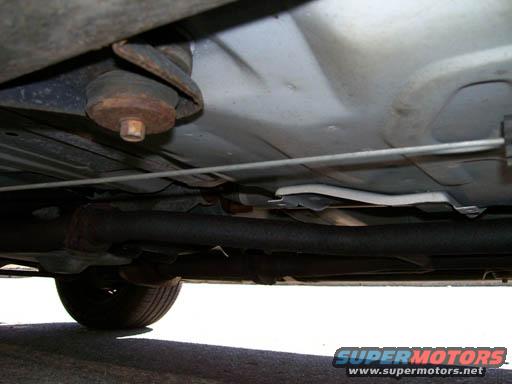 Underbody view of a 1999 Ford Crown Victoria showing suspension components and exhaust pipe