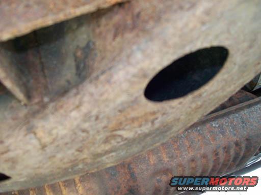 rusted metal frame and undercarriage components of a vehicle