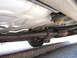 1999 Ford Crown Victoria - Underbody view of a 1999 Ford Crown Victoria, showing the exhaust system and suspension components.