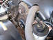 1999 Ford Crown Victoria - Close-up of engine components including belts and pulleys, with a power steering fluid reservoir.
