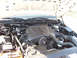 1999 Ford Crown Victoria - The engine bay of a 1998 Ford Crown Victoria is visible with the hood open, revealing the engine components.