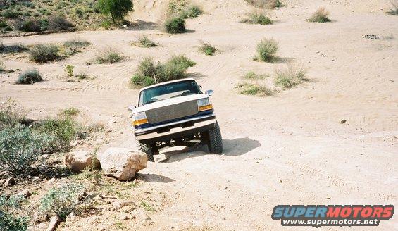 Ford F-Series truck navigating rocky desert terrain