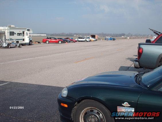 Dark green car front corner with Supermotors logo and date 01/23/2005