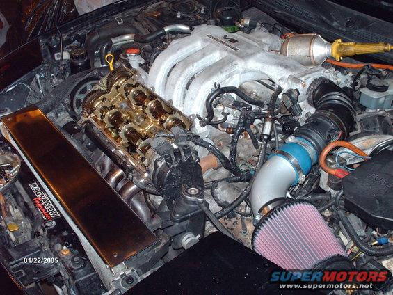 Engine bay with V6 intake manifold, exposed camshafts, and aftermarket air filter. Date stamp reads 01/22/2005