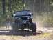 1989 Ford Bronco - Jeep Wrangler navigates an off-road obstacle course on logs.