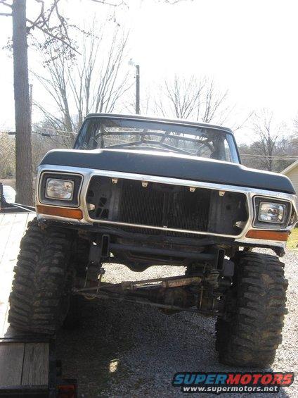 1979 Ford Bronco front end with large tires and no grille