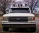 1989 Ford Bronco - This white Ford F-Series truck features a roof-mounted light bar and a prominent grille.