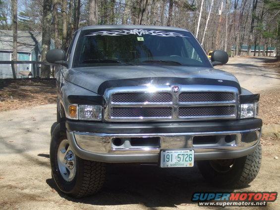 Gray Dodge Ram pickup truck, front view, with chrome grille and bumper. License plate reads 191 5726