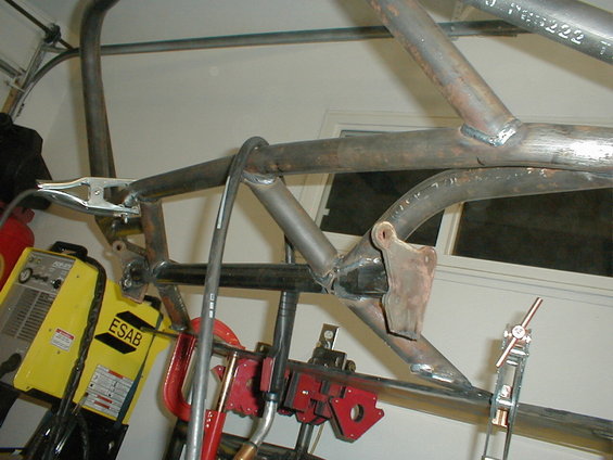 welding clamps on metal tubing, ESAB welder in background