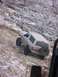 1996 Ford Bronco - A white Ford Bronco navigates a challenging rocky incline covered in snow and frost.