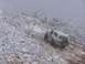 1996 Ford Bronco - A white 1996 Ford Bronco navigates a challenging, snow-covered incline amidst a foggy, winter landscape.
