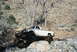 1986 Ford Bronco - A modified pickup truck navigates a rocky off-road course, its suspension and tire grip.