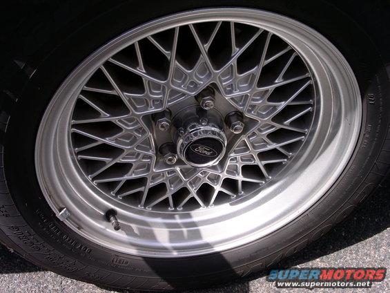 Close-up of a silver mesh-spoke wheel with a Ford logo center cap