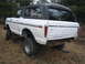 1979 Ford Bronco - Rear view of a white 1978 Ford Bronco with a black hardtop, parked outdoors. Price is marked on the window.