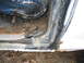 1979 Ford Bronco - Close-up view of the interior door frame and a torn seat, showing signs of wear and rust.