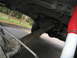 1974 Ford F-100 - Underside view of a truck's driveline components, including the driveshaft and differential, with a prominent red and white shock absorber…