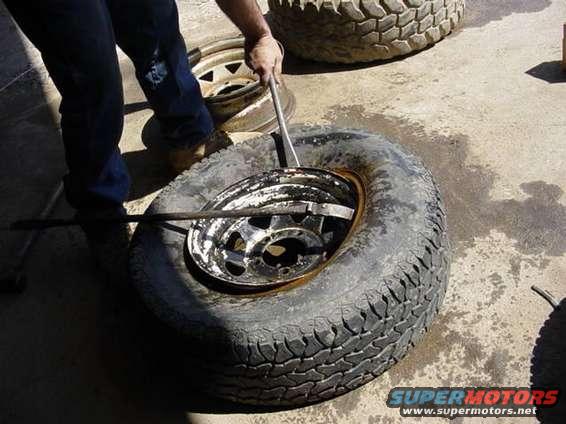 tirebars.jpg tires must go off and on the rim from the front!!!    
Two tire bars required.  Do one first and start to bring the lip over the rim edge while you are pushing down on the side 180* from where your prying it up so it drops down into the drop center and allows the side you are prying to go over the rim.  do this side to side till that first bead is off the rim.  