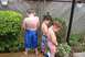 1976 Ford F-150 - Three young boys urinate outdoors in a backyard setting next to a wooden fence.