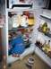 1976 Ford F-150 - A child is inside a refrigerator, surrounded by food and drink containers.