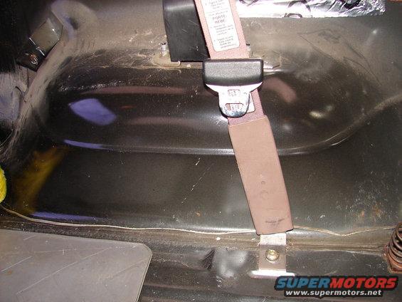 Close-up of a seatbelt anchor and strap inside a vehicle