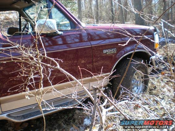 Maroon 1996 Ford Bronco with tan trim, seen from the front 3/4 view