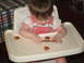 1966 Ford Ranchero - A baby sits in a high chair, reaching for snacks on the tray.