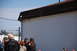 1996 Ford Bronco - A group of people stand outside a building under a clear blue sky. The building has white siding and a dark roof.