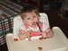 1966 Ford Ranchero - A baby sits in a high chair, holding a wrench and surrounded by food, with a checkered tablecloth in the background.