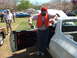 1966 Ford Ranchero - A man stands by the open door of a white vehicle at an outdoor gathering with other cars and people.