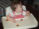 1966 Ford Ranchero - A baby sits in a high chair, holding a spoon and surrounded by cookies.