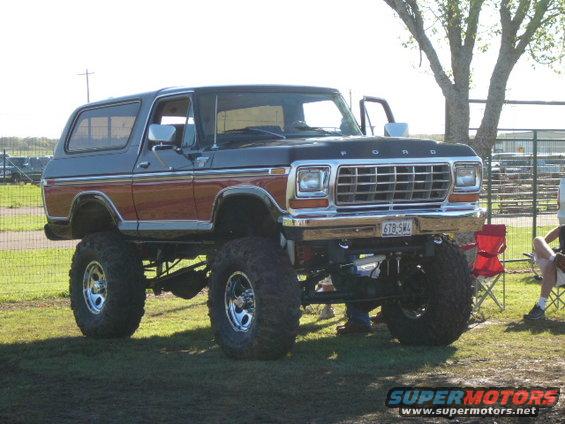 Black and brown lifted 1978 Ford Bronco with chrome grille and large tires