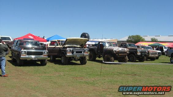 Brown 1978 Ford Bronco parked under a red tent, front view