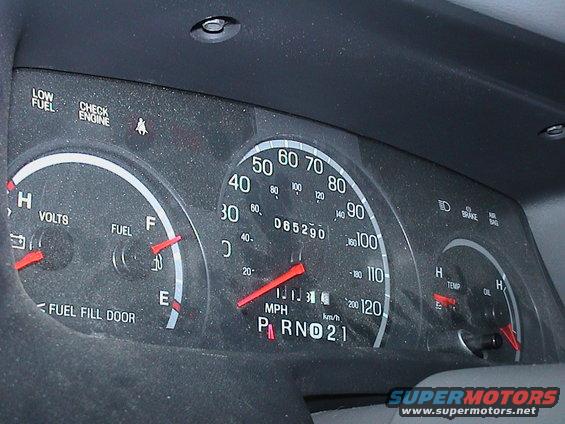 Interior dashboard gauges with speedometer, fuel, volts, temperature, and oil gauges visible